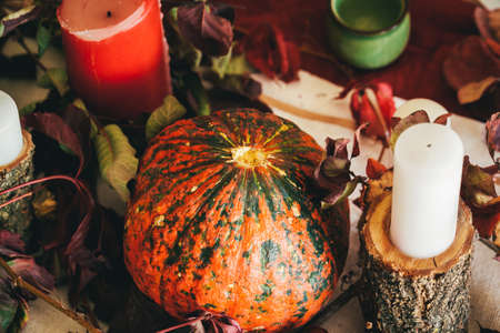 Fall thanksgiving decor with candle and pumpkins close upの写真素材