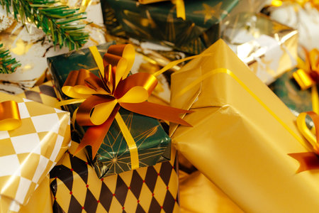 Pile of wrapped green and gold presents for Christmasの写真素材