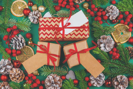 Craft christmas gifts with red ribbons on decorated christmas background