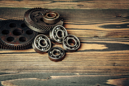 Car parts gears and bearings on wooden backgroundの写真素材