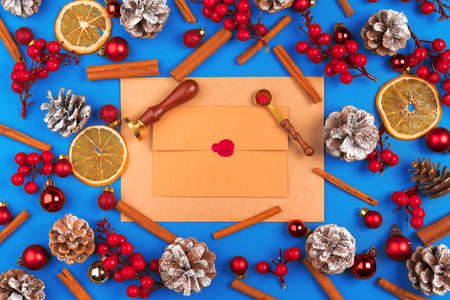 Desk with envelope and Christmas decorations. Flat lay. Mockupの写真素材