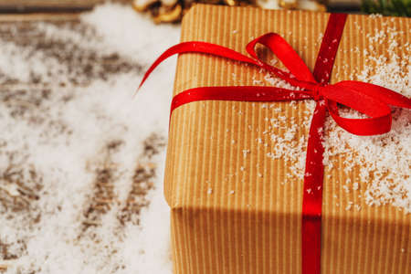 Craft gift boxes over snowy wooden table close upの写真素材