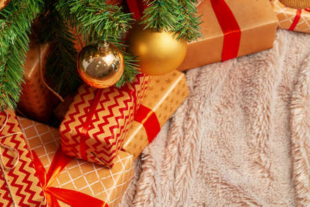 Stack of wrapped presents under Christmas treeの写真素材