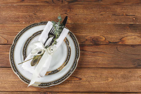 Vintage table setting on wooden table with floral decor