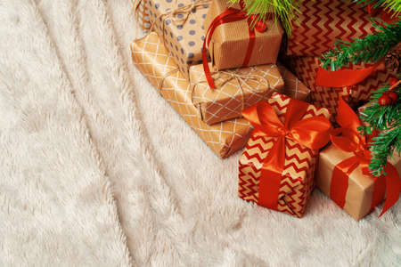 Stack of wrapped presents under Christmas tree