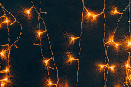 Warm light illuminated garland close up on dark background