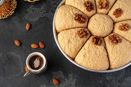Turkish dessert baklava with nuts on black background