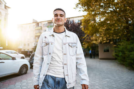 Portrait of handsome young casual man walking on the streetの写真素材