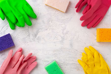 Sponges and rubber gloves for cleaning on gray backgroundの写真素材