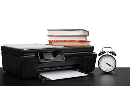 Working table with printer and stacked books on white abckgroundの写真素材