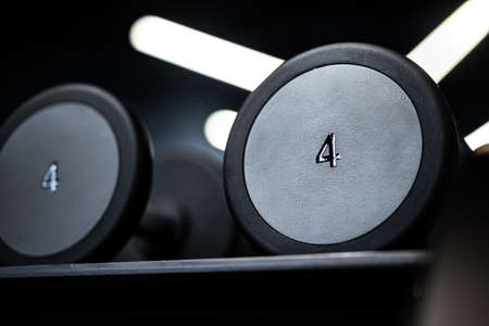Close up of new dumbbells on a rack in a gymの写真素材
