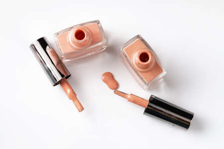 Close up of a nail polish puddle over white background