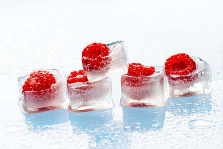 Ice cubes with frozen berries inside close upの写真素材