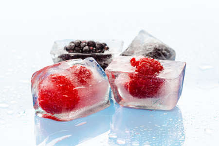 Ice cubes with frozen berries inside close upの写真素材