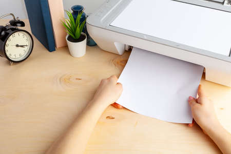 Close up of woman using a printer machine
