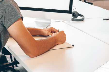 Unrecognizable man working in a modern officeの写真素材