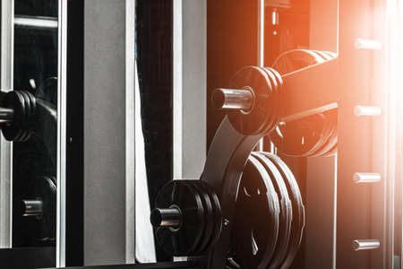 Gym weight plates on holder close up
