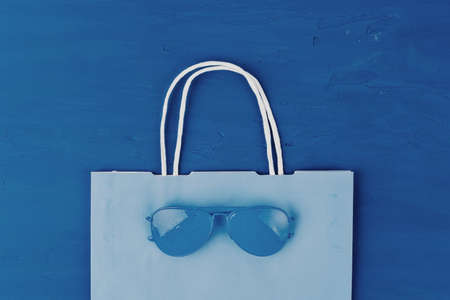 Blue aviator glasses on classic blue background, top viewの写真素材