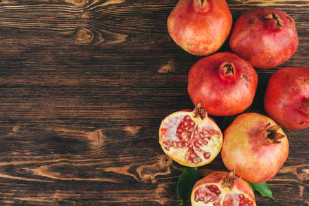 Pile of ripe pomegranate on wooden backgfroundの写真素材