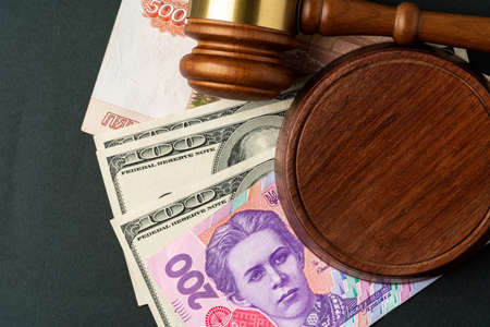 Money banknotes with judge gavel. Corruption concept with currency of Russian Rubles, Ukrainian...