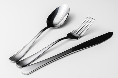 Spoon, fork and knife on a white background