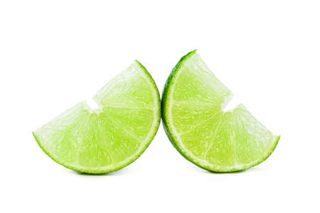 Pieces of lime isolated on white backgroundの写真素材