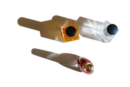 Set of perfume bottles on a bright light with shadowsの写真素材