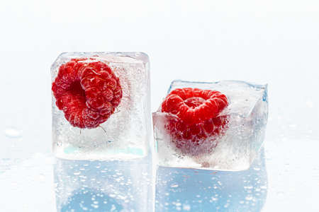 Ice cubes with frozen berries inside close upの写真素材
