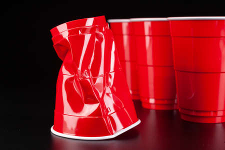 Red plastic cups and ball for game of beer pongの写真素材