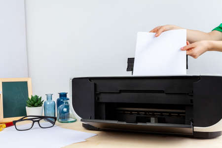 Hands of a woman using a copying machine close upの写真素材