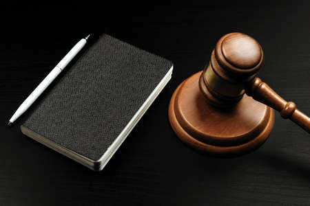 Image of wooden judge hammer on notepad