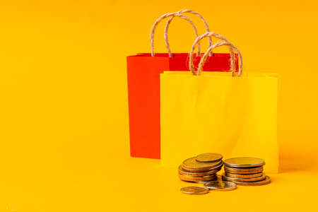 Shopping concept. Shopping bag with stack of coinsの写真素材