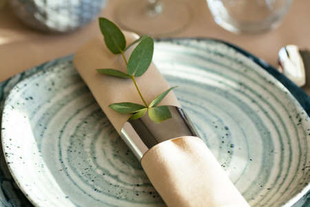 Stylish serving on a green ceramic plate with cotton napkinの写真素材