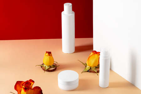 Cosmetic bottles with rose petals, copy spaceの写真素材