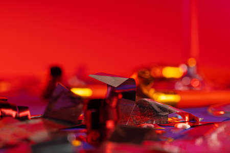 Glitter confetti lying on paper background close upの写真素材