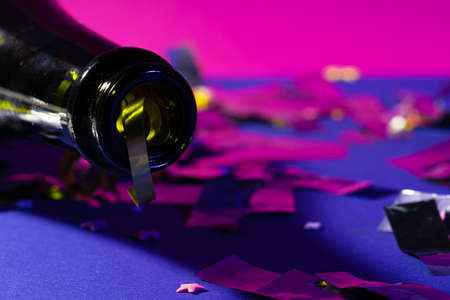 Champagne bottle on a purple background close up. Party conceptの写真素材