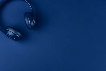Blue headphones on blue background, top viewの写真素材