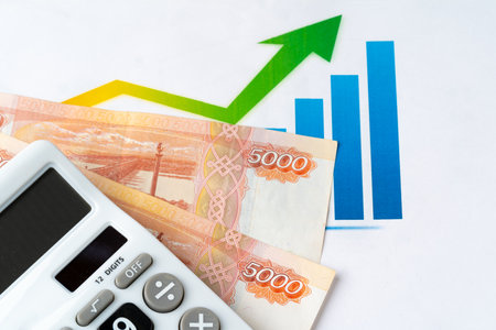 Financial chart with Russian rubles money stack with calculator. Currency appreciation conceptの写真素材