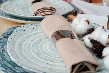 Beautiful table setting decorated with cotton budsの写真素材