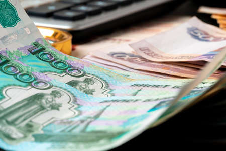 Close up photo of stack of Russian money rubles with calculator