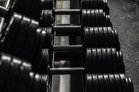 Sports equipment in gym. Dumbbells of different weight close upの写真素材