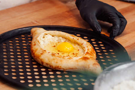 Cook hands preparing khachapuri in a cafe close upの写真素材