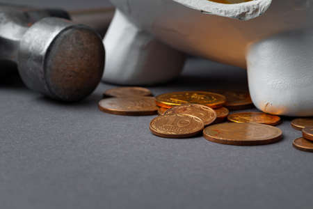 Broken piggy bank with ukrainian hryvnia coins. Poverty concept