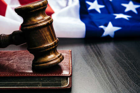 Gavel on wooden table with USA flag