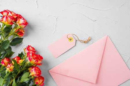 Pink envelope with flowers, top view. Romantic letter