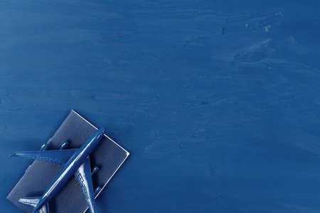 Toy plane on classic blue background, top viewの写真素材