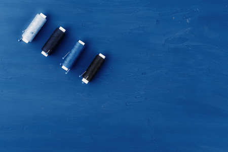 Tayloring accessories on classic blue background, top view