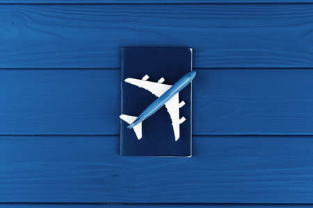 Toy plane on classic blue background, top view