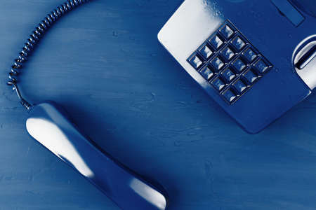 Retro telephone of blue color on classic blue backgroundの写真素材