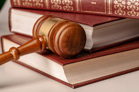 Judge gavel and legal book close up on table